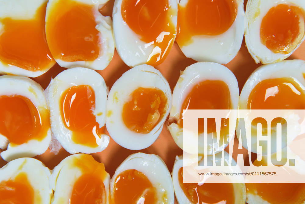 Top view of full frame background of fresh soft boiled eggs arranged in rows on table