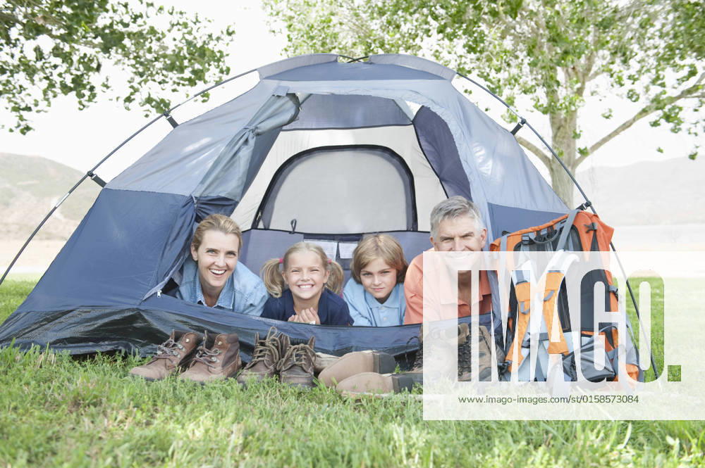 Family of four smiling from a tent, model released, , property released, , 10124428.jpg, Outdoors,Day,Smiling,people,Family,Mother,Children,Side By Side,Parents,leisure activity,Camping,Lake,Backpack,Countryside,Footwear,Caucasian,outside,Lying On Stomach,Tent,Looking At Camera,camping equipment,rural,lakeside,four people,Family Holiday,Activity Holiday,Walking Boots,Adventure Holiday,Outdoor Activity,family vacation,Camping Pitch,Tent Flap, California