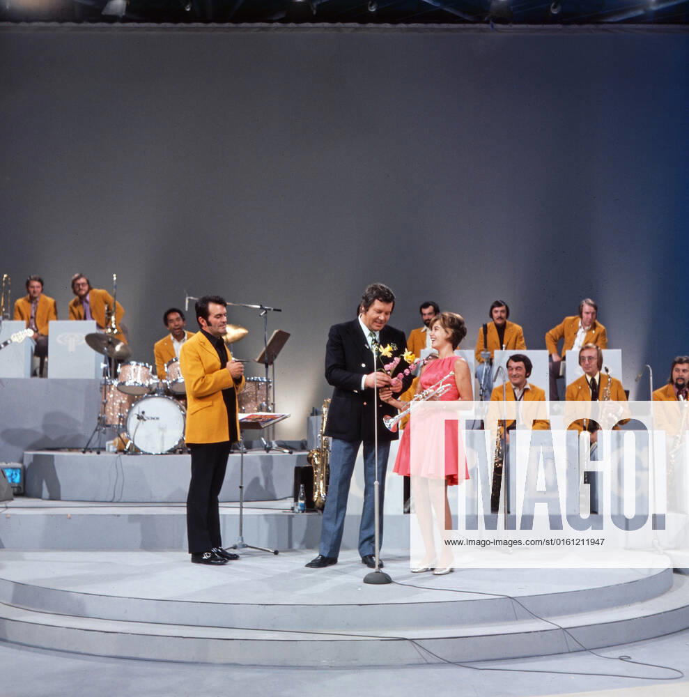 DREI MAL NEUN Drei mal Neun, ZDF Quizshow, Deutschland, 1971, im Bild: Max Greger mit Bigband, Showmaster Wim Thoelke und Trompetensolistin Carole Dawn Reinhart. Drei mal Neun, TV quiz show, Germany, 1971, on the photo: Max Greger and his Big band, presenter Wim Thoelke and the American trumpet soloist Carole Dawn Reinhart, Deutschland