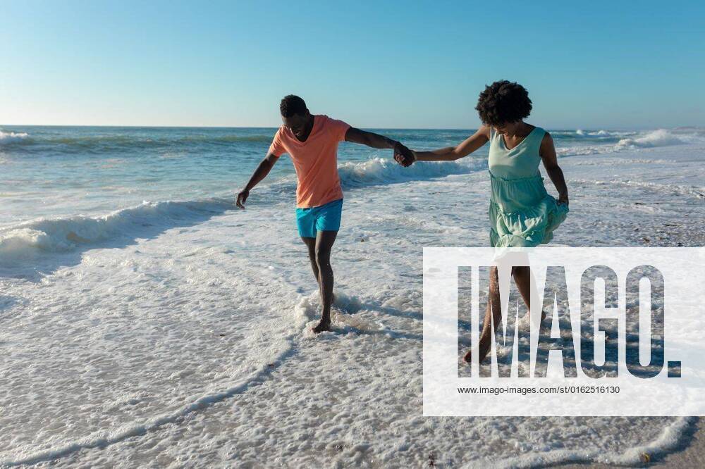 African american couple holding hands wading on shore at beach against sky during sunny day African american couple holding hands wading on shore at beach against sky during sunny day. unaltered, lifestyle, love, togetherness and holiday concept., model released, , property released, Cape Town, South Africa, , 3137198.jpg, people,african american,couple,holding hand,wading,shore,beach,sky,sunny day,unaltered,lifestyle,love,togetherness,holiday concept,coast,sea,ocean,vacation,sand,summer,travel,landscape,together,water,happy,young,outdoor,beautiful,nature,coastline,tourism,leisure,sun,relationship,african,american,holding,hand,sunny,day,holiday,concept Young Adult,Man,Male,Black,Woman,Female