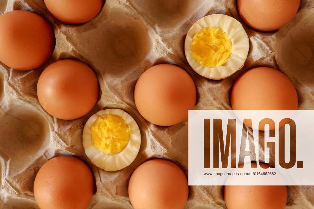 Eggs in paper tray. one soft-boiled. view from top. Boiled halve, Eggs in paper tray. one soft-boiled. view from top.Boiled halved eggs., Eggs in paper tray. one soft-boiled. view from top.Boiled halved eggs., 27.06.2020,