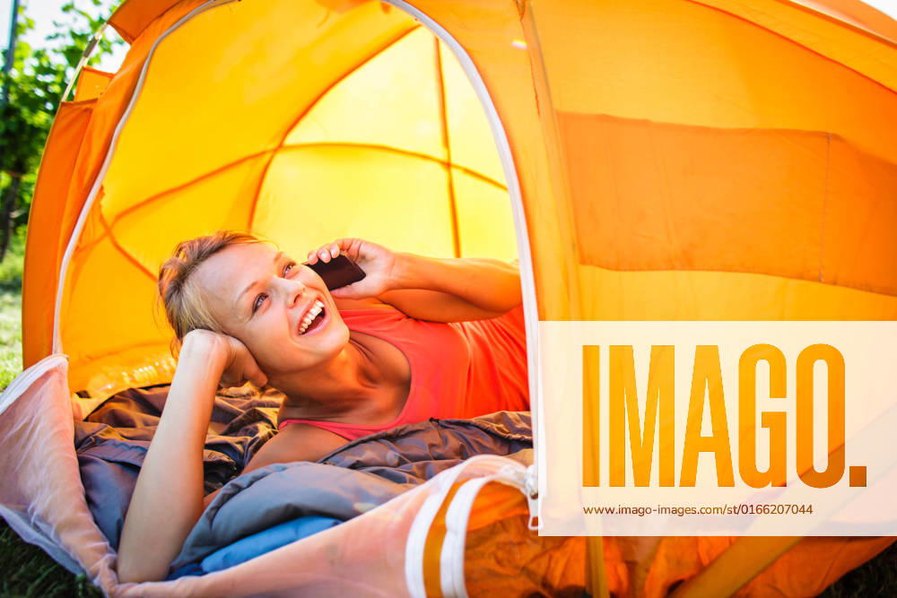 Pretty, young woman camping outdoors, lying in the tent in the morning, using her smart phone, model released, , 17068848.jpg, PHONE, Reach, activity, adult, alone, beautiful, camping, caucasian, cell, cellular, cheerful, communication, european, female, happiness, happy, holding, human, independent, indoors, istanbul, laying, leisure, lying, message, mobile, morning, nature, networking, office, one, park, people, person, recreation, relax, relaxation, resting, smile, spring, summer, technology, tent, using, vacation, woman, women, working, young, youth,