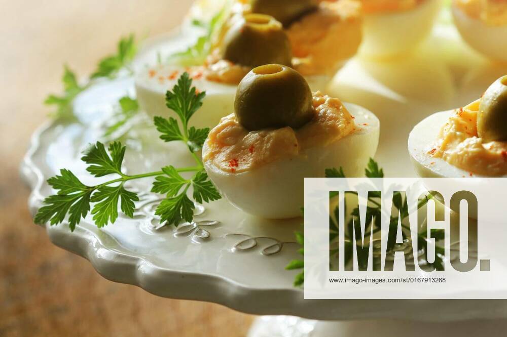 Spicy deviled eggs garnished with green olives, Spicy deviled eggs garnished with green olives ., Spicy deviled eggs garnished with green olives ., 07.02.2022,