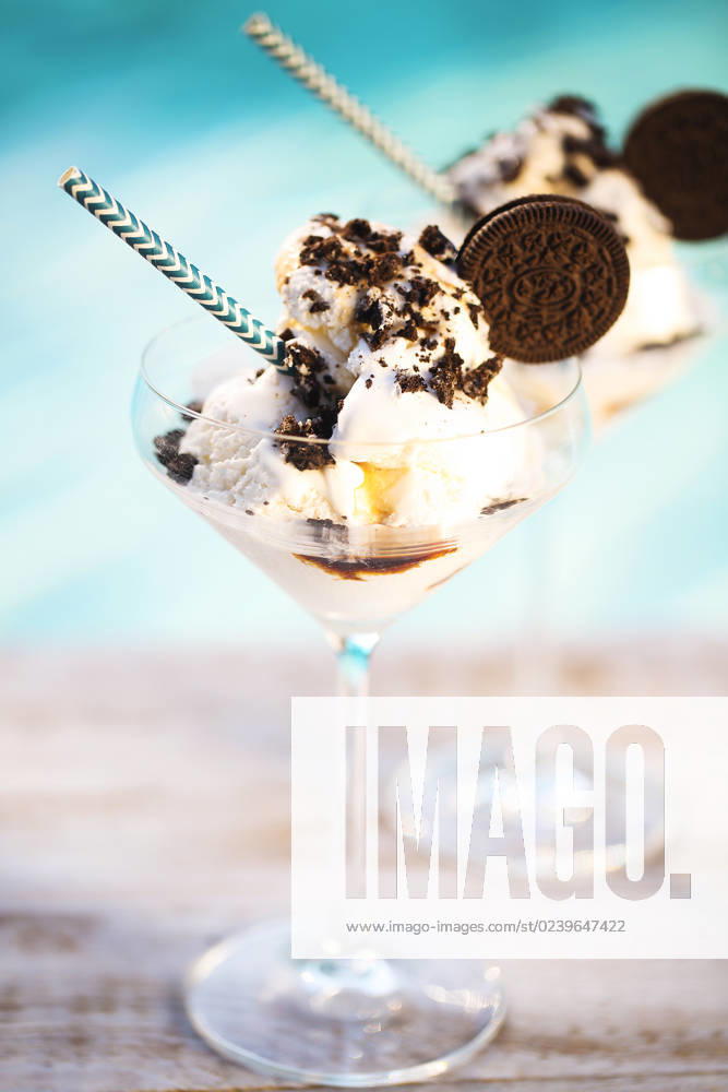 Vanilla sundae ice cream with chocolate sauce and cookies Vanilla ice cream with chocolate sauce and cookies by the pool