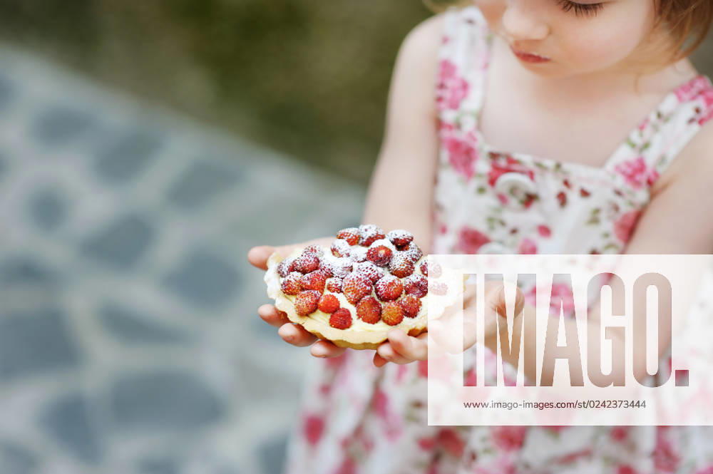 Little girl eating a strawberry tart outdoors, model released, , 31961518.jpg, adorable, cake, casual, caucasian, cheerful, child, childhood, color, cupcake, cute, daughter, dessert, domestic, dress, eating, enjoying, enjoyment, female, floral, food, fruit, fun, girl, happiness, happy, healthy, home, horizontal, kid, life, lifestyle, looking, love, meal, mealtime, morning, nutritive, people, person, red, self, small, smile, standing, strawberry, sugar, sweet, tart, tasty, young