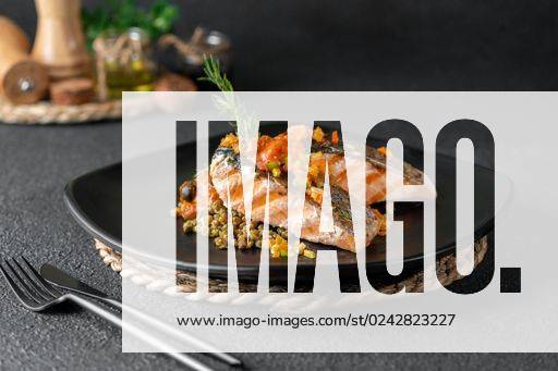 A closeup of a plate of grilled salmon with beans garnished with rosemary on the table *** einer closeupe des einer Teller des gegrillt Lachs mit Bohnen garniert mit Rosmarin am der Tisch 10588189