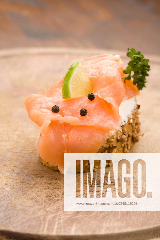 Photo of delicious crispy cereals bread with smoked salmon
