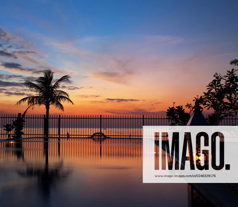 Stunning sunset with a reflection in infinity pool
