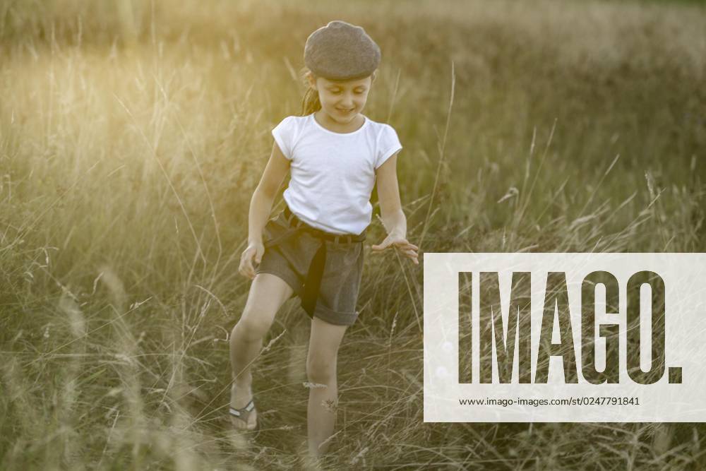 Girls with Cap, 8 years, at Sunset in the Meadow