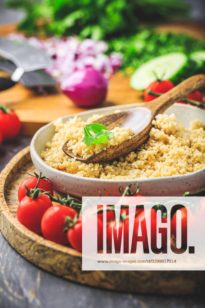Preparing traditional oriental salad Tabouleh with couscous or bulgur Preparing traditional oriental salad Tabouleh with couscous or bulgur, ingredients on cutting board