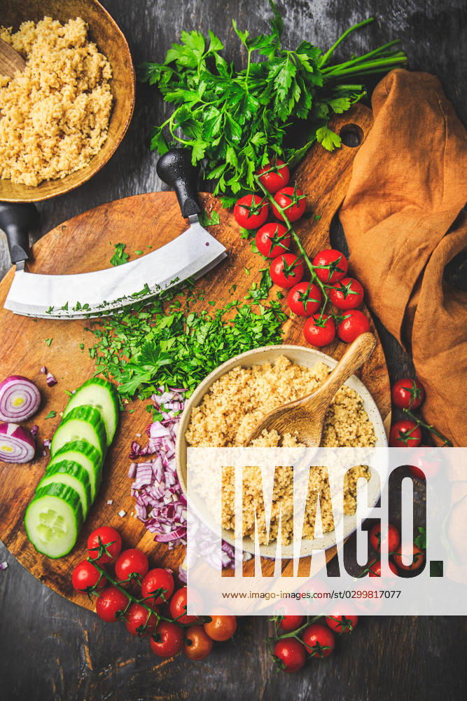 Preparing traditional oriental salad Tabouleh with couscous or bulgur Preparing traditional oriental salad Tabouleh with couscous or bulgur, ingredients on cutting board