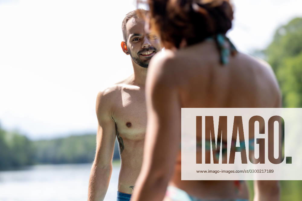 CREATIVE - Paar am See in Berlin Berlin, Deutschland - 25. Juli 2023: (CREATIVE) Ein Mann und eine Frau (Models) genießen einen Sommertag an der Krummen Lanke, einem See in Berlin. Berlin