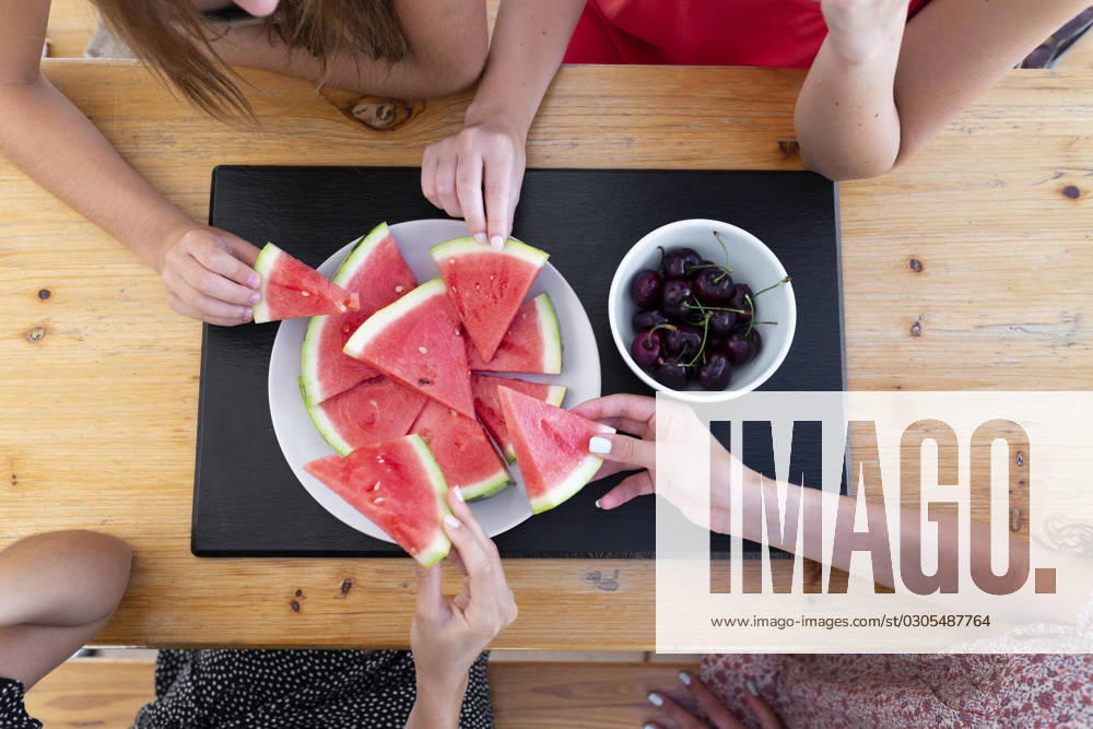 Friends having watermelon and cherries at table model released, Symbolfoto property released, JPTF01287