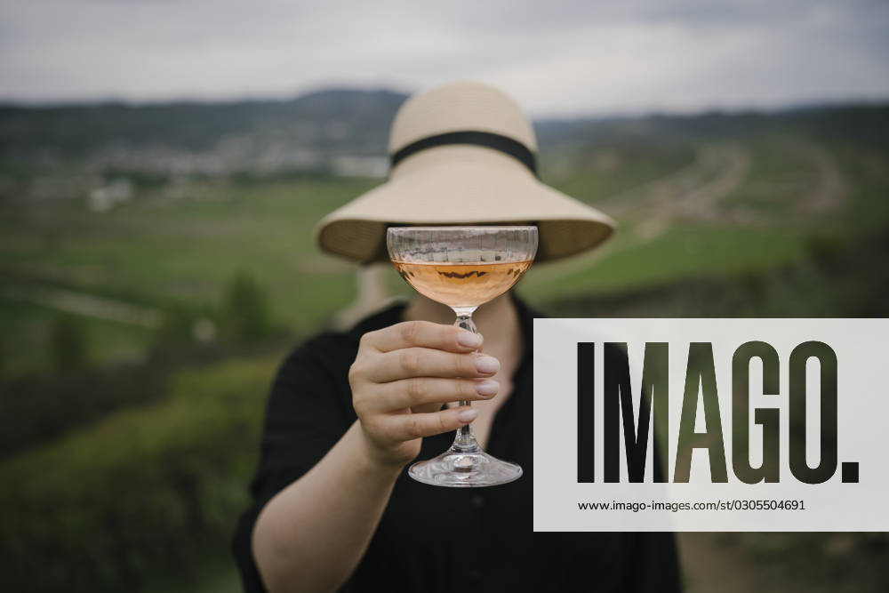 Woman hiding face with rose wine glasses model released, Symbolfoto, YBF00128
