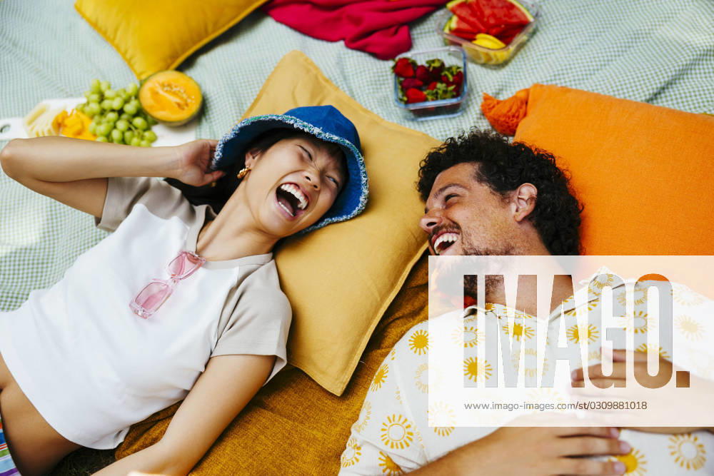 Happy friends enjoying together and lying on picnic blanket model released, Symbolfoto, EBSF03762
