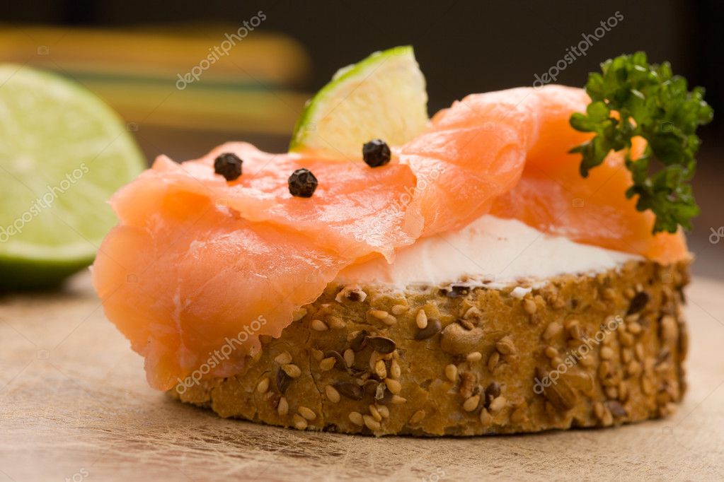 Photo of delicious crispy cereals bread with smoked salmon model released