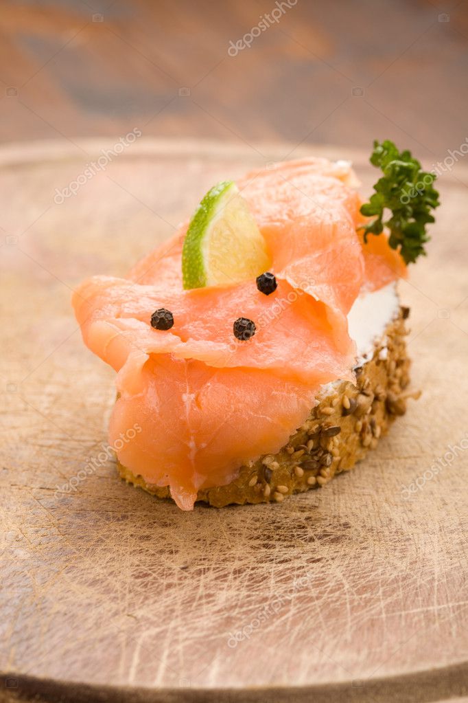 Photo of delicious crispy cereals bread with smoked salmon model released