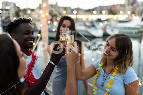 Group of multiracial friends having fun on boat party in summer vacation - Happy diverse young people cheering with champagne on a birthday celebration friends, happy, boat, party, diverse, celebrate, young, fun, champagne, holidays, vacation, celebration, people, group, drink, man, woman, lights, family, multiracial, smile, cheerful, cheering, toast, bonding, cheers, multicultural, adult, harbour, together, friendship, enjoy, colleague, guy, african, diversity, weekend, laughing, multiethnic, laugh, usa, young adult, event, festive, having fun, united states, african american