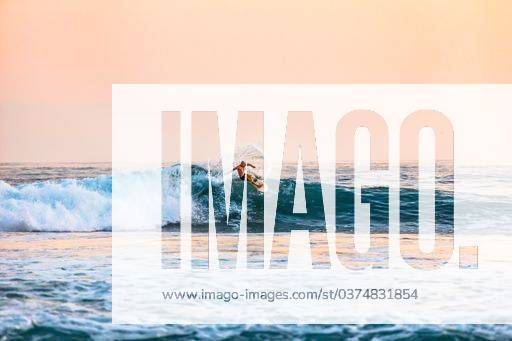 A shot of a male surfing on the sea during daytime 28305 RECORD DATE NOT STATED