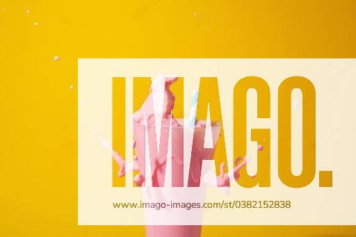 A glass of strawberry smoothie isolated on yellow and pink background 1043356 RECORD DATE NOT STATED