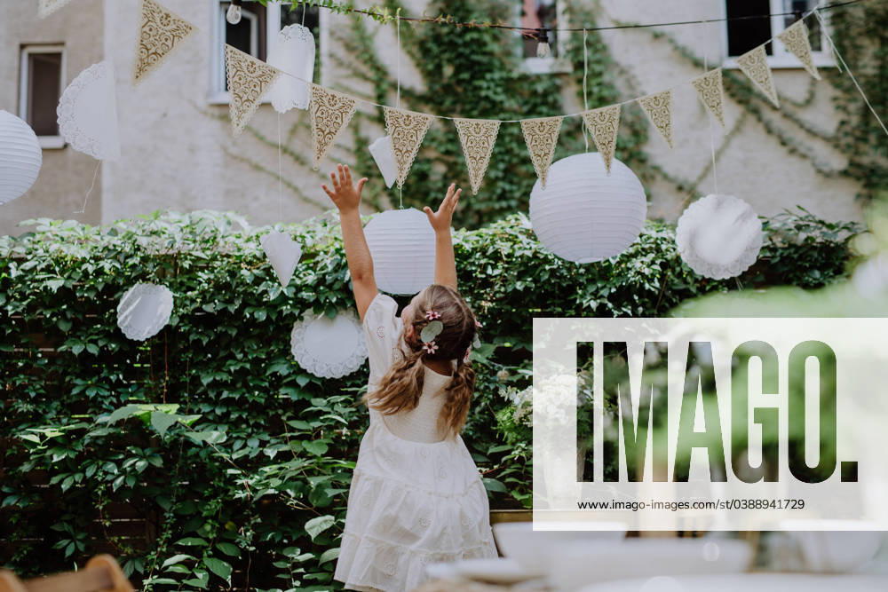 Rear view of happy little child playing with wedding decorations. Rear view of happy little child playing with a wedding decorations. model released