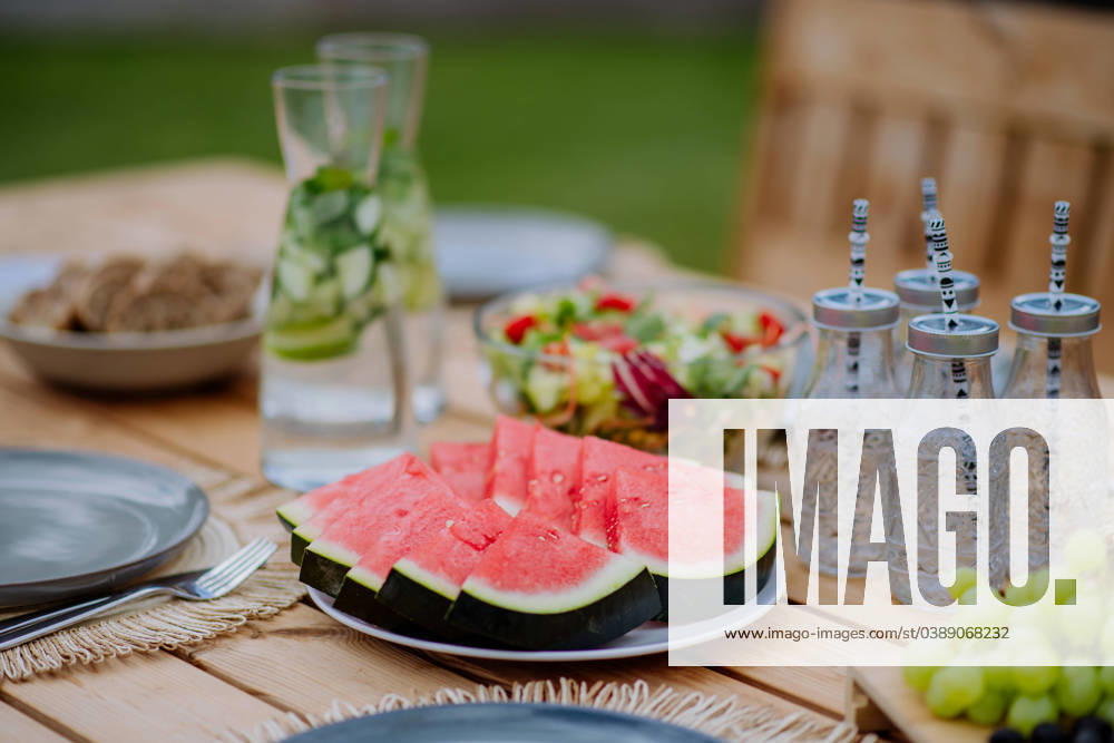 Dining table set for dinner on the terrace in summer, garden party concept. A dining table set for dinner on the terrace in summer, garden party concept. model released