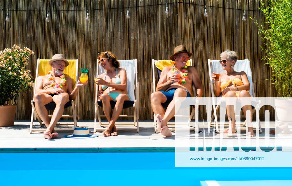 Group of cheerful seniors sitting by swimming pool outdoors in backyard. Group of cheerful seniors sitting by swimming pool outdoors in backyard, relaxing. model released