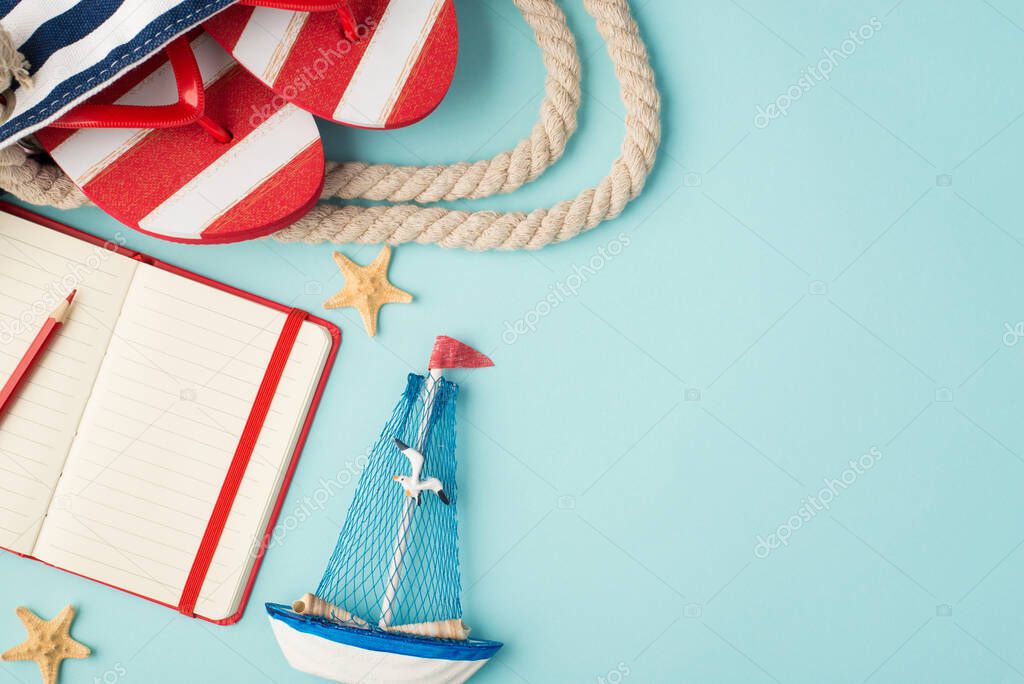 Top view photo of striped flip-flops in beach bag red copybook with pencil yacht toy and starfishes on isolated pastel blue background with copyspace