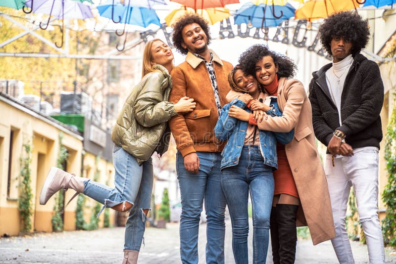 Group of multiracial friends having fun together outdoor, Group of multiracial friends having fun together outdoor in the city. Happy mixed race girls and boys smiling to the camera. Young people lifestyle concept