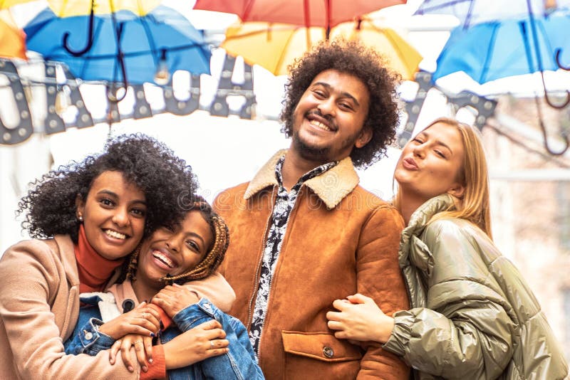 Group of multiracial friends having fun together outdoor, Group of multiracial friends having fun together outdoor in the city. Happy mixed race girls and boys smiling to the camera. Young people lifestyle concept