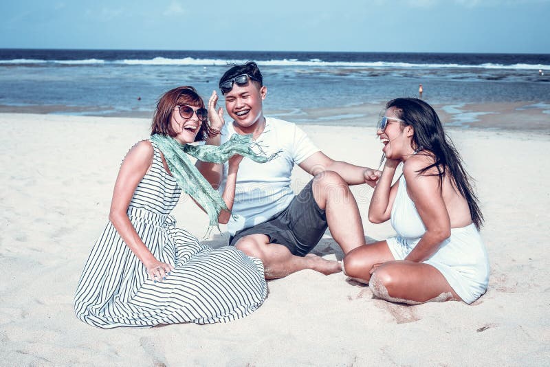 Group of multiracial friends having fun on the beach of tropical Bali island, Indonesia., Group of multiracial friends having fun on the beach of tropical Bali island.
