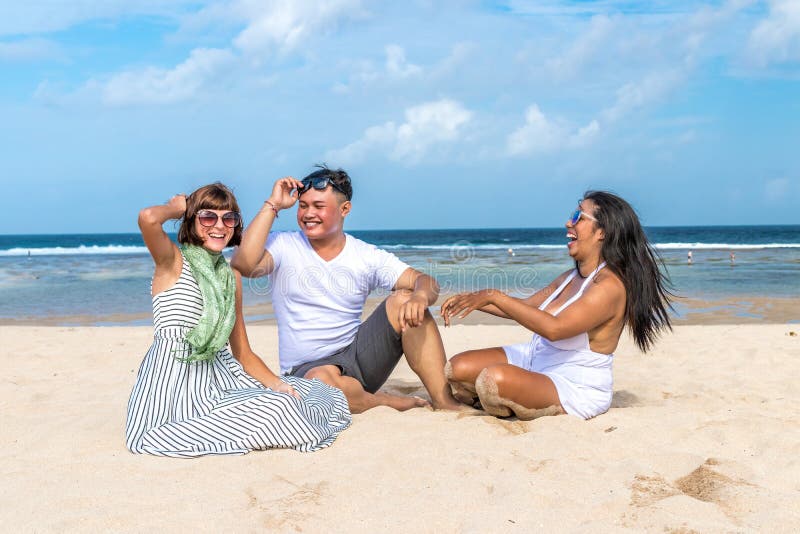 Group of multiracial friends having fun on the beach of tropical Bali island, Indonesia., Group of multiracial friends having fun on the beach of tropical Bali island.