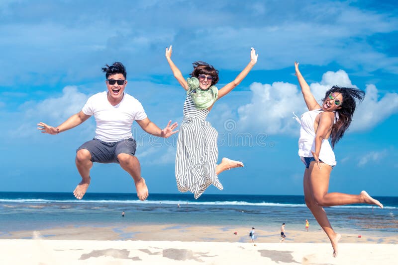 Group of multiracial friends having fun on the beach of tropical Bali island, Indonesia., Group of multiracial friends having fun on the beach of tropical Bali island.