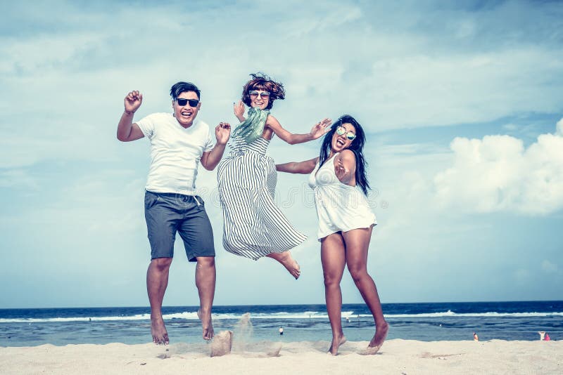 Group of multiracial friends having fun on the beach of tropical Bali island, Indonesia., Group of multiracial friends having fun on the beach of tropical Bali island.