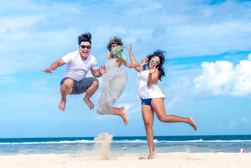Group of multiracial friends having fun on the beach of tropical Bali island, Indonesia., Group of multiracial friends having fun on the beach of tropical Bali island.