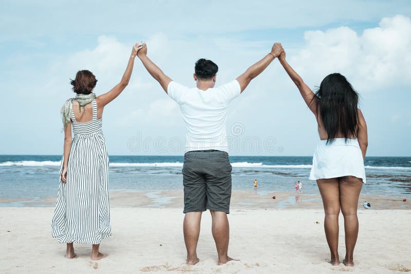 Group of multiracial friends having fun on the beach of tropical Bali island, Indonesia., Group of multiracial friends having fun on the beach of tropical Bali island.