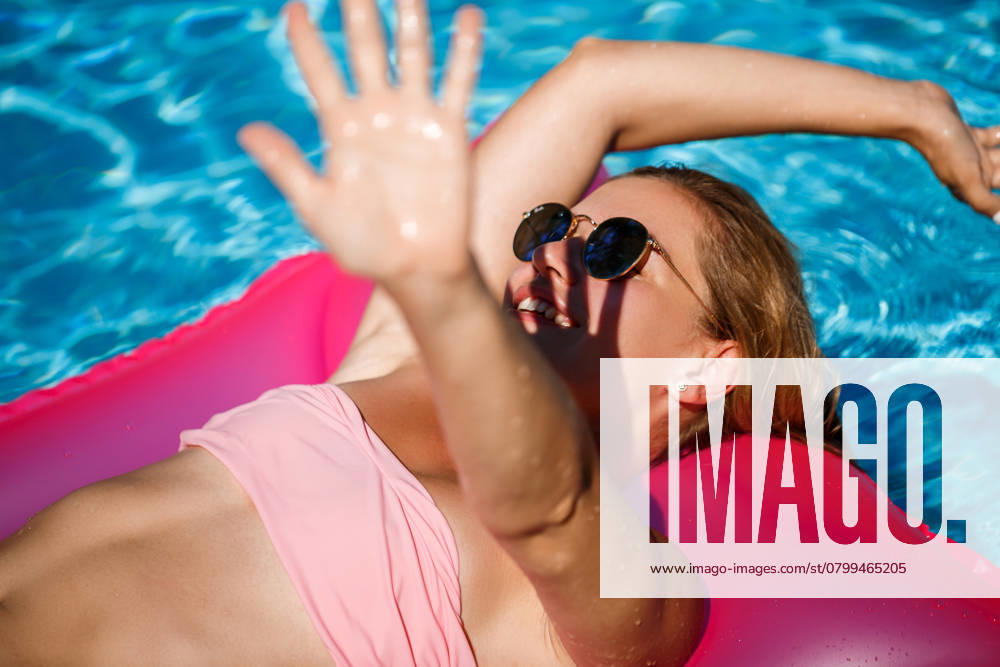 Woman model in sunglasses resting and sunbathing on a mattress in the pool. Woman in a pink bikini swimsuit floating on an inflatable pink mattress. spf and sunscreen, model released, , 49138770.jpg, woman, beach, fashion, water, person, girl, summer, bikini, vacation, pool, recreation, relax, air, model, top, tan, sexy, space, sunbathing, travel, mattress, leisure, lifestyle, young, beautiful, bed, blue, copy, copyspace, lying, overhead, summertime, body, happy, female, outdoors, fun, view, aerial, inflatable, relaxation, swimsuit, pink, swim, swimming, raft, sea, tropical, holiday, sunny RECORD DATE NOT STATED