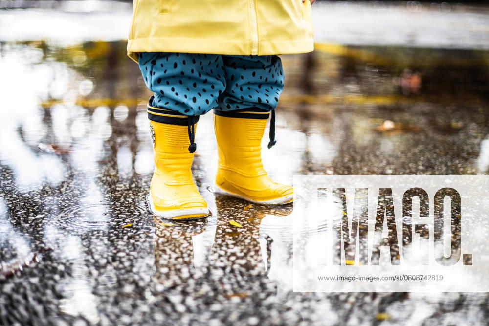 Small infant boy wearing yellow rubber boots and yellow waterproof raincoat standing in puddle on a overcast rainy day. Child in the rain, model released, , 57653774.jpg, rain, child, puddle, infant, fun, boots, weather, playful, raincoat, waterproof, yellow, childhood, season, rain boots, happiness, baby, boy, wet, rainy, kid, happy, joy, water, summer, spring, lifestyle, autumn, galoshes, outdoors, toddler, kids, rubber boots, duckling, young, clothing, game, fashion, preschool, umbrella, foot, legs, little, fall, boot, person, nature, park, outside, reflection, activity RECORD DATE NOT STATED