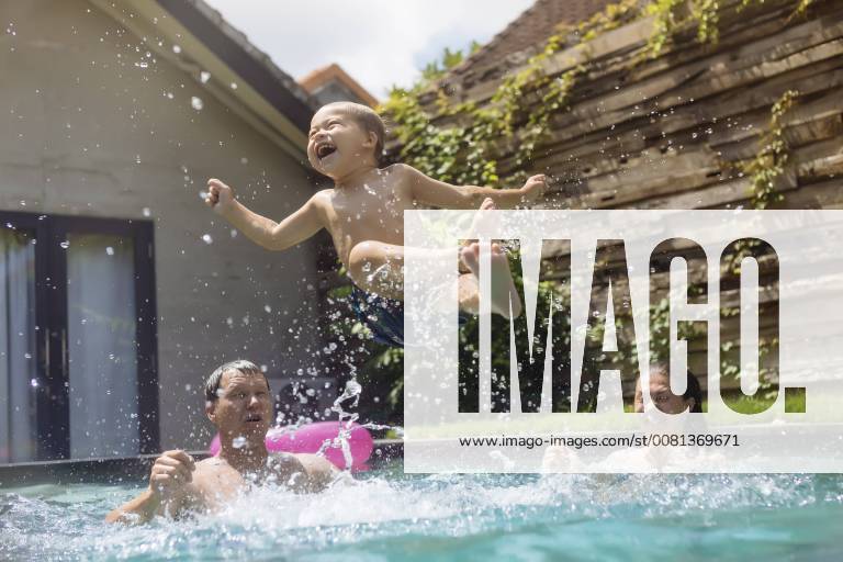 Happy family having fun in swimming pool model released Symbolfoto property released KNTF00931
