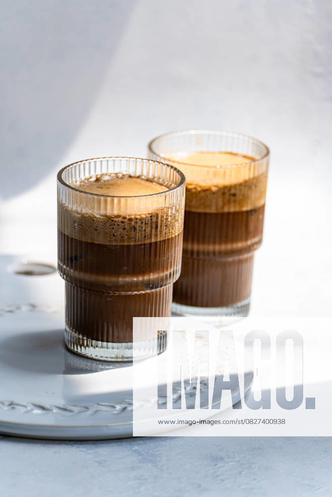 IMAGO Creative, Food, Trend, Iced Coffee Refreshing cold cappuccino in clear glass Two refreshing cold cappuccinos served in elegant clear glasses, creating a delightful blend of coffee and frothy milk. Perfect for a rejuvenating coffee break anytime Model Released AnnaBogush_ID30387_1025194_004