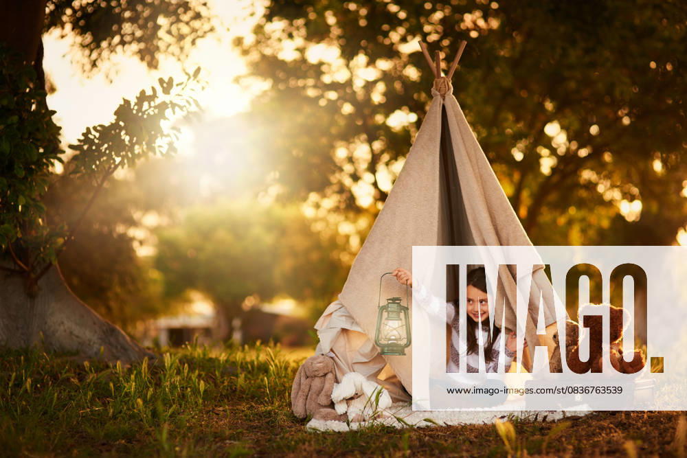 Teepee, child and fun in garden tent outdoor in nature for camping, playing and adventure with sunlight. Cloth, lamp and fantasy house for girl in forest with imagination, suitcase and teddy bear Teepee, child and fun in garden tent outdoor in nature for camping, playing and adventure with sunlight. Cloth, lamp and fantasy house for girl in forest with imagination, suitcase and teddy bear., model released, , 59845556.jpg RECORD DATE NOT STATED