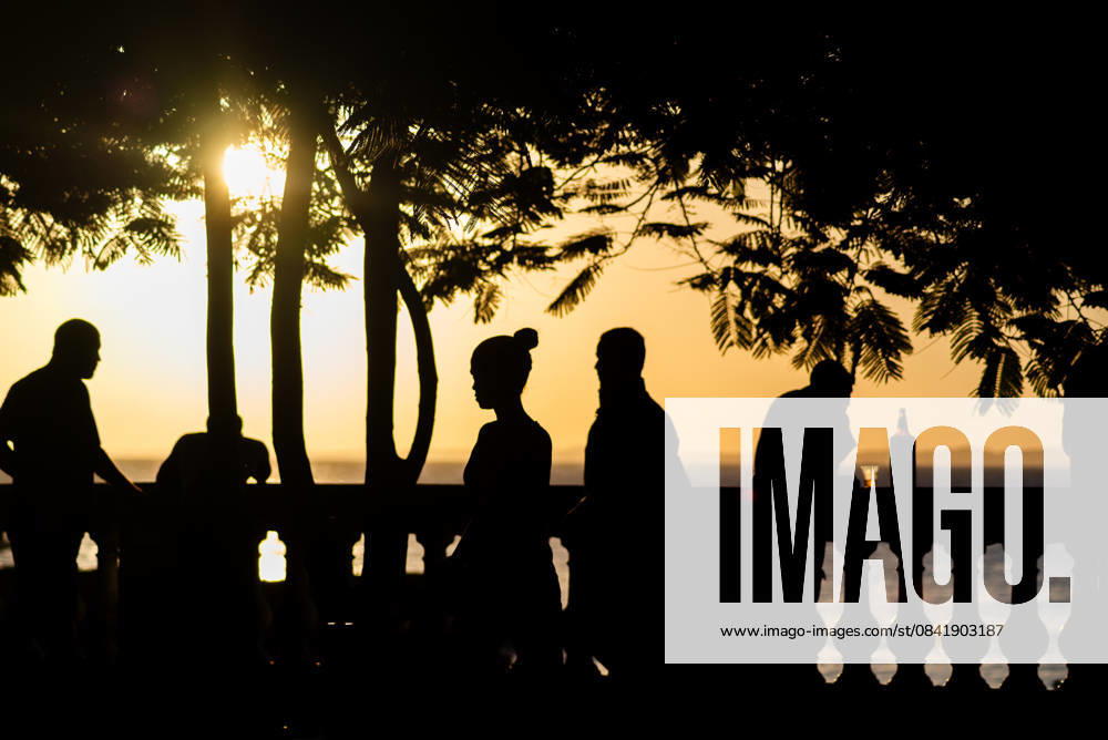 View of people in silhouette watching the sunset on Porto da Barra beach. City of Salvador, Bahia. Salvador Bahia Brazil