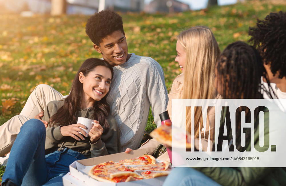 Group of multiracial friends having fun at public park Group of multiracial happy friends having fun at public park, eating pizza and talking, model released, , 61571544.jpg RECORD DATE NOT STATED