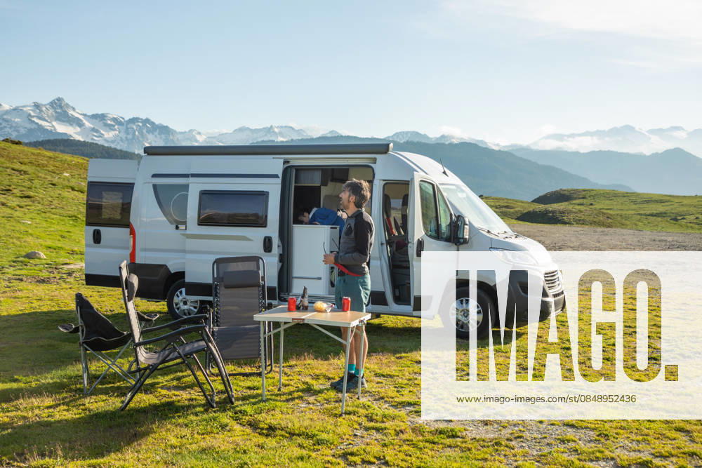Camper van adventure in the scenic Pyrenees region A couple enjoys a serene camper van adventure amidst the breathtaking landscapes of the Pyrenees. The picturesque setting provides a perfect escape into nature s beauty. Model Released Robcabphotography_ID32893_1119988_002