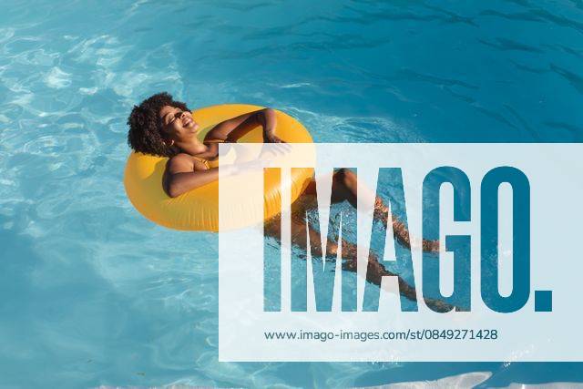 Mixed race woman sunbathing on inflatable in swimming pool Mixed race woman sunbathing on inflatable in swimming pool. Hanging out and relaxing outdoors in summer., model released, , property released, Cape Town, South Africa, 14.01.2021, 1405023.jpg, people,mixed race,woman,sunbathing,inflatable,swimming pool,hanging,relaxing,outdoors,summer,nature,landscape,outdoor,travel,vacation,beautiful,water,sky,green,beach,sea,park,spring,sunny,day,tourism,natural,leisure,lifestyle,sun,mixed,race,swimming,pool Young Adult,Woman,Female,Black