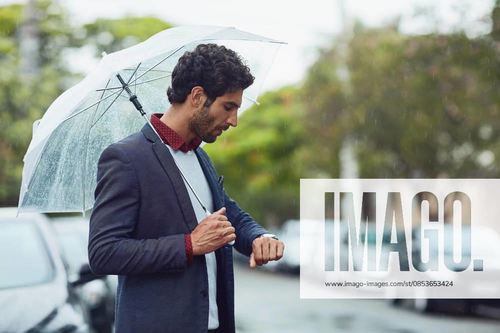 Cropped shot of a handsome young businessman on his morning commute in the rain. (License=RF) ,model released, Symbolfoto
