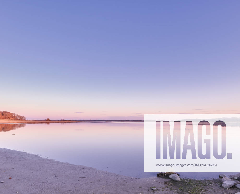 Beautiful landscape banner view of the ocean on the coast against a pink sunset in the sky in summer. Relaxing copyspace view of the calm sea water and beach at the seashore along the coastline. (License=RF) ,model released, Symbolfoto