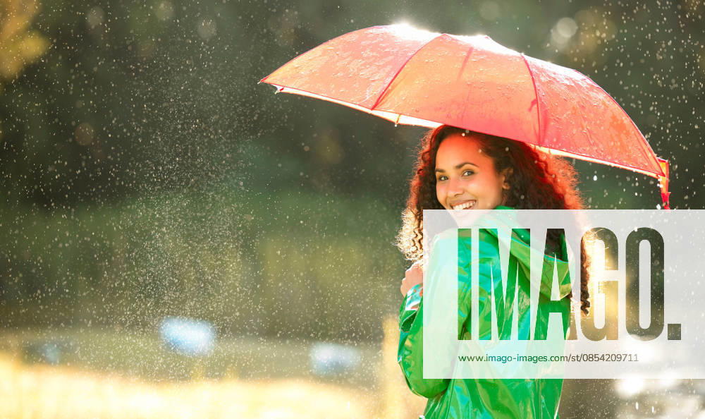 The rain is calling and I must go. a beautiful young woman spending a day outside in the rain (License=RF) ,model released, Symbolfoto