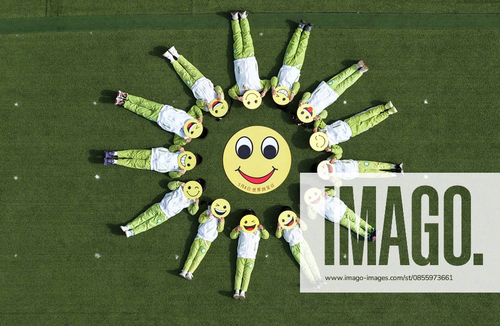 Kindergarten children form a smiley face pattern on the playground to welcome the World Smile Day on May 8, 2026 in Yangzhou, Jiangsu Province of China. May 8 marks the World Smile Day.