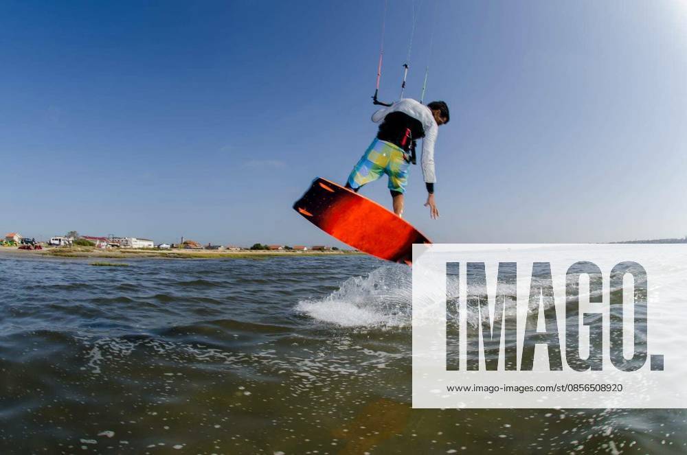 Kiteboarder flying over the water on a sunny day. model released Symbolfoto
